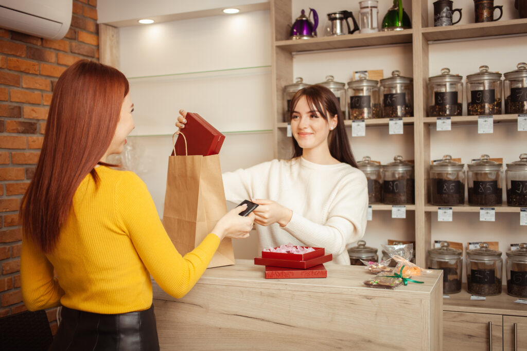 female buyer pays with bank card in tea shop happ 2022 01 20 03 33 17 utc